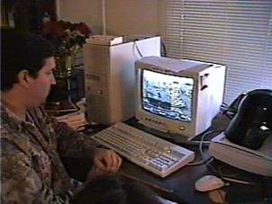 A person sitting at a desk with a computer and a keyboard

Description automatically generated with low confidence