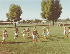 A group of children playing football

Description automatically generated with medium confidence