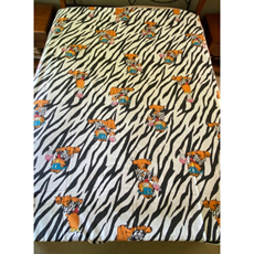 A bed with zebra print sheets

Description automatically generated