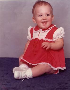 A baby in a red dress

Description automatically generated