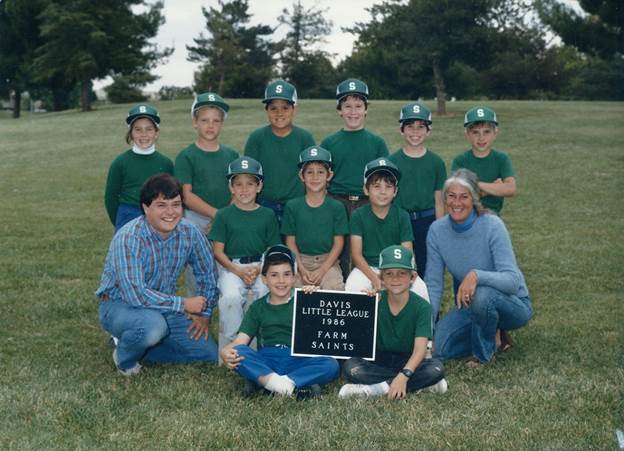 A group of people wearing green shirts and holding a sign

Description automatically generated with medium confidence