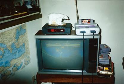 A cat sitting on top of a television

Description automatically generated with low confidence