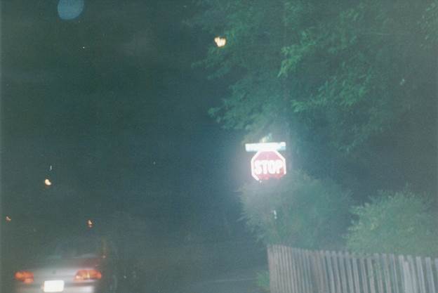 A stop sign at night

Description automatically generated