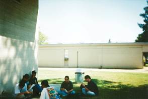 A group of people sitting on the grass

Description automatically generated with low confidence