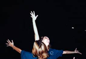 A group of women with arms raised

Description automatically generated